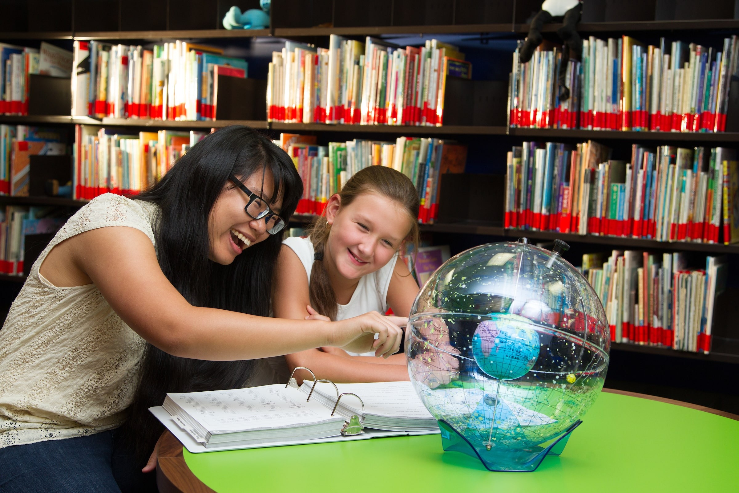 Student and teacher with globe at LUOA Affiliate Program