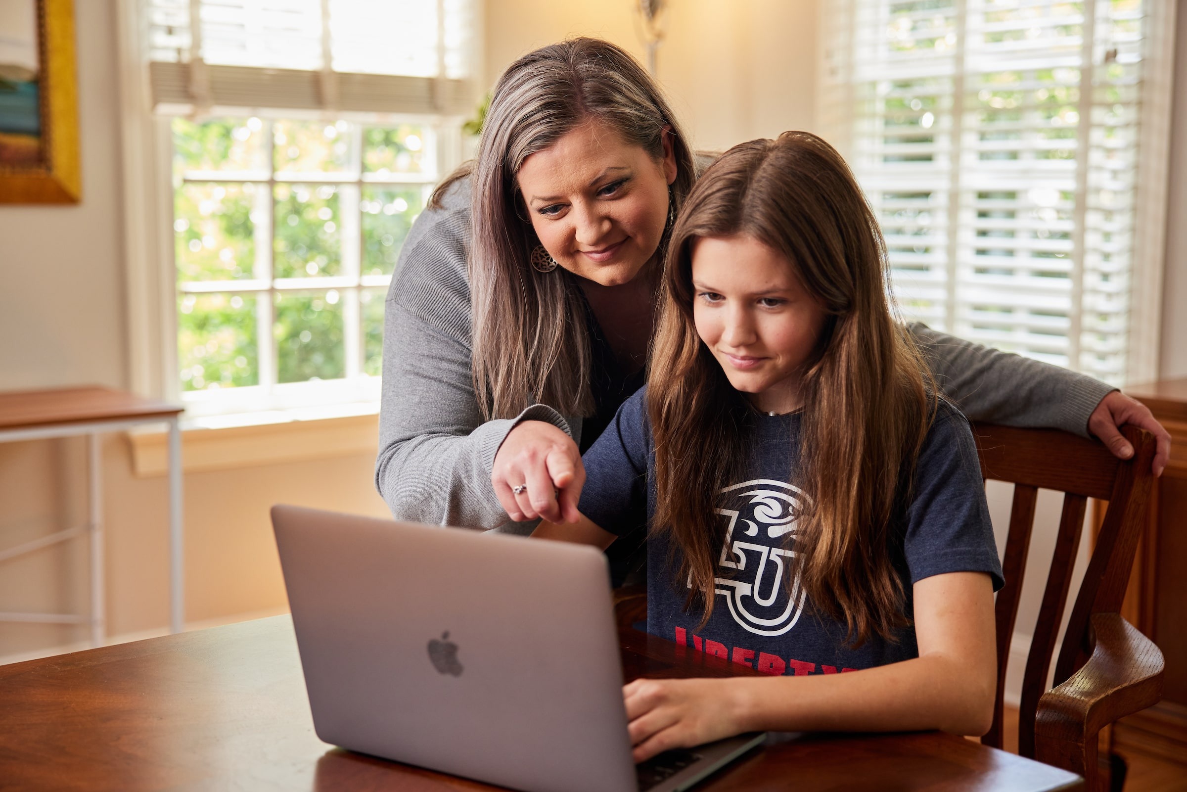 Mother helping daughter navigate LUOA course work