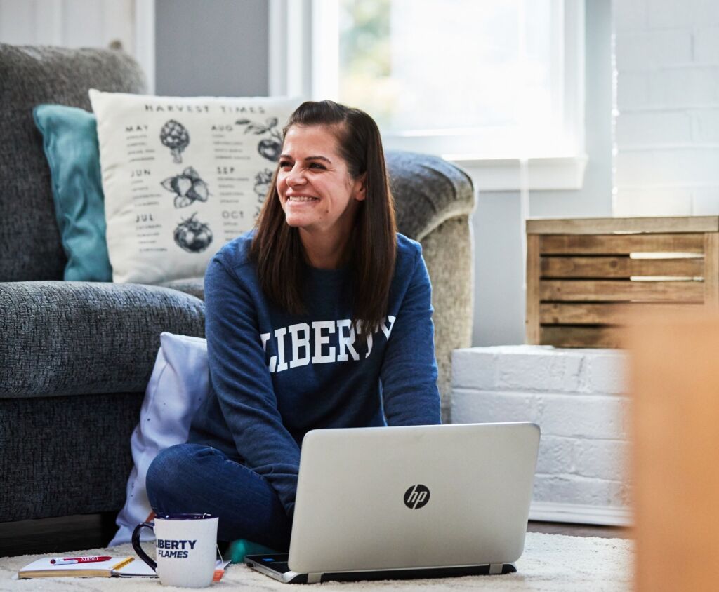 Student on computer smiling