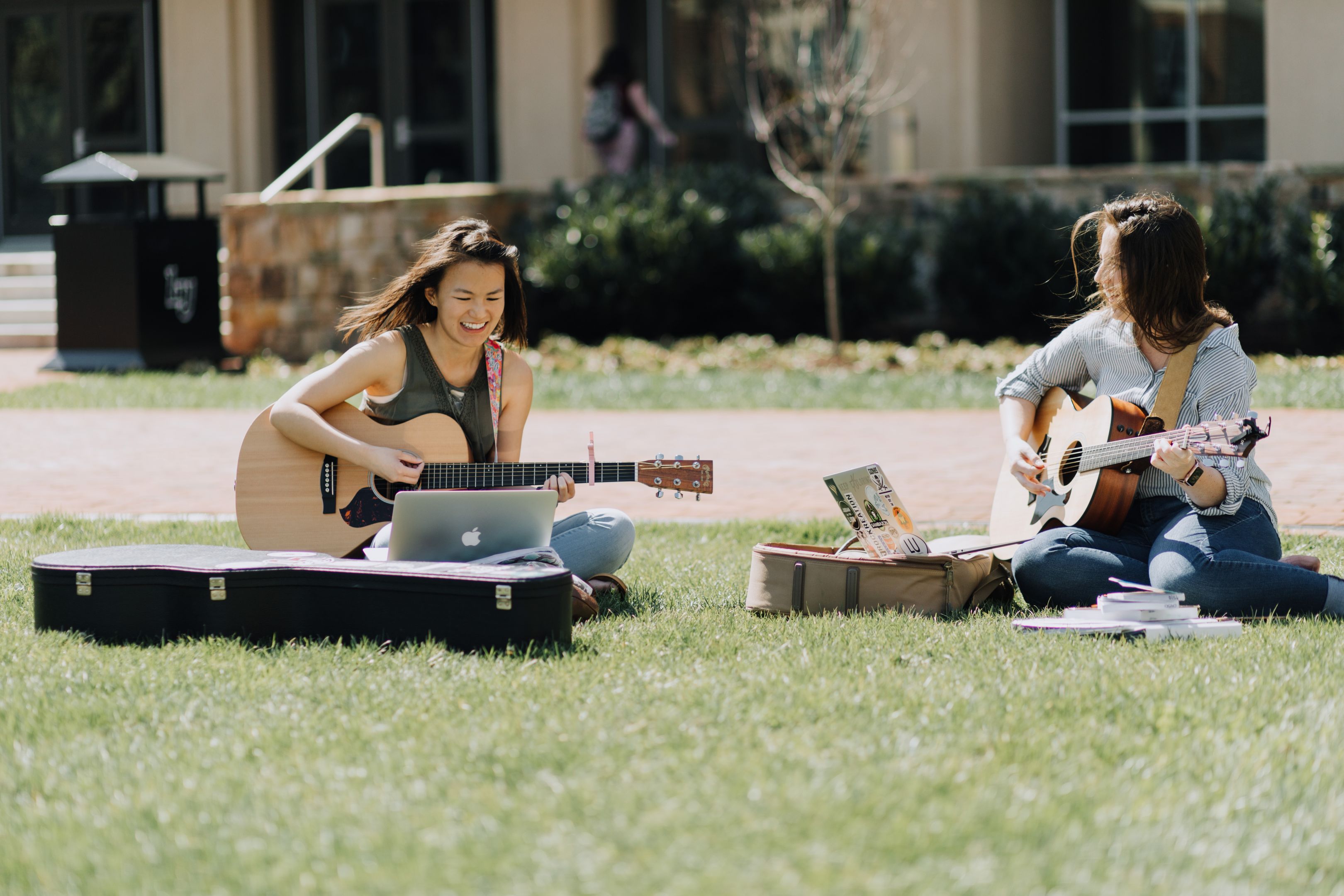 Female Students Playing Guitar on Academic Lawn